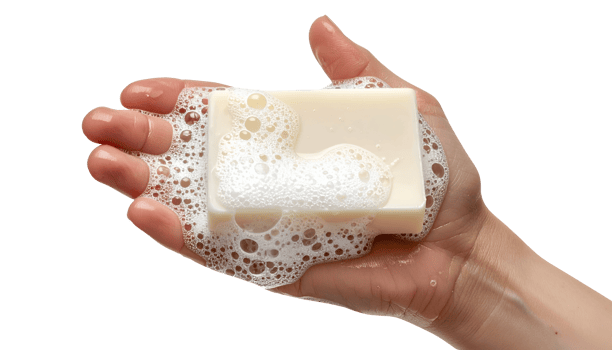 Bar of creamy white soap with thick foam and bubbles held in hand on isolated background png