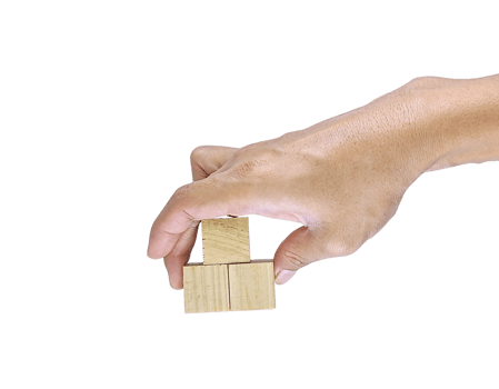 A close-up of a human hand holding a square wooden block, isolated on a white background. The image conveys a concept of simplicity, raw material, or basic structure. png