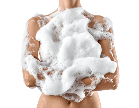 Torso of woman covered in rich white soap foam during cleansing on isolated white background png