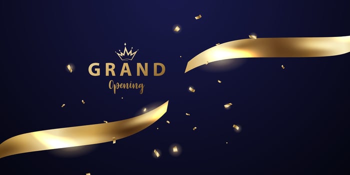Golden ribbon with the word grand opening vector