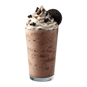 Chocolate milkshake with whipped cream and cookie topping in a glass png