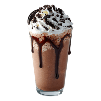 Chocolate milkshake topped with whipped cream and cookie crumbles drizzled with chocolate sauce png