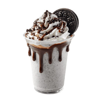 Delicious milkshake with whipped cream chocolate sauce and cookie png