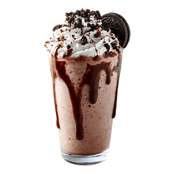 Delicious chocolate milkshake topped with whipped cream chocolate cookie crumbs and a chocolate drizzle png