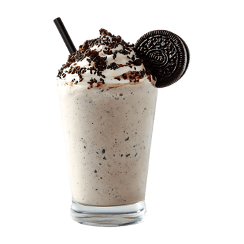 Delicious milkshake with whipped cream chocolate cookie crumbs and a cookie on top in a glass with a straw png