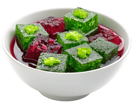 Colorful jelly cubes in white bowl, featuring vibrant green and red pieces topped with small green leaves, isolated on transparency background, refreshing and appetizing dessert png