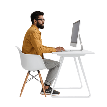 Man working at minimalist white desk setup showcasing modern workplace productivity and style png