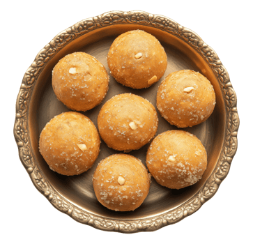 Golden yellow ladoo sweet balls arranged on ornate brass plate isolated on transparent background, top view png