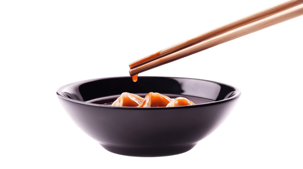 Enjoying the savory taste of dumplings dipped in soy sauce with wooden chopsticks for an authentic flavor png