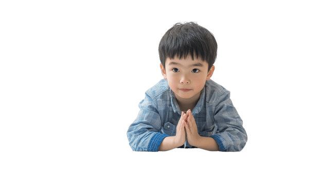 A young boy kneels with clasped hands, showing a moment of reflection and tranquility against a simple backdrop png