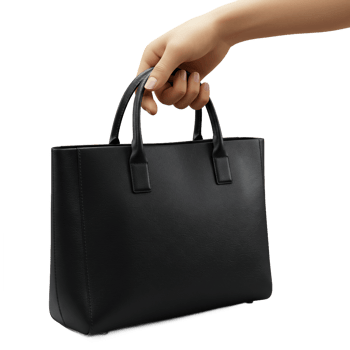 Black tote bag held by hand isolated on transparent background professional accessory png