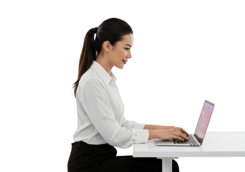 Asian young adult female working on laptop at desk in profile view. png