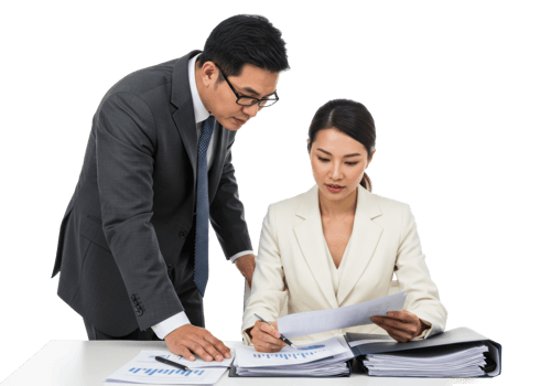 Asian business professionals reviewing documents in a meeting. png