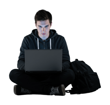 Young caucasian male in hoodie using laptop while sitting cross legged. png