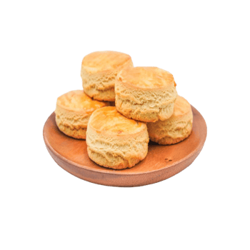 Golden biscuits isolated on transparent background, stacked high on a wooden plate png