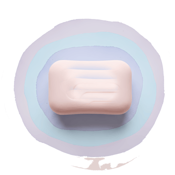 Aerial view of a bar of soap on a light blue surface with a circular gradient design around it on transparent background png
